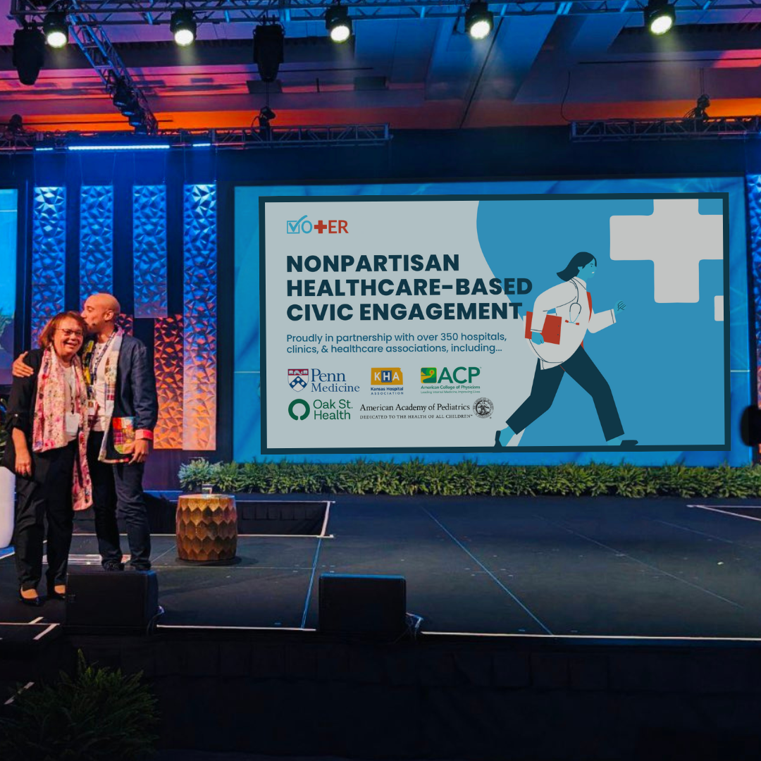Founder Dr. Alister Martin presenting at NextMed with audience watching presentation of Vot-ER nonpartisan healthcare-based voter registration
