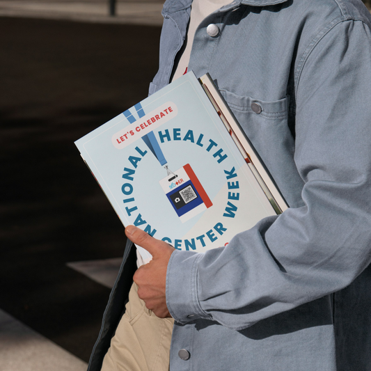 Person holding a printed version of the 'National Health Center Week' toolkit
